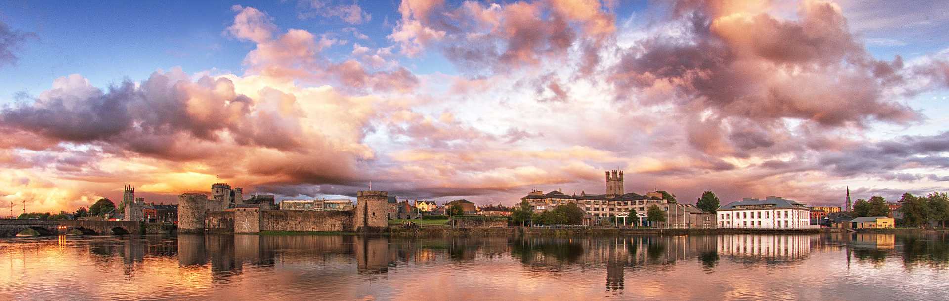 Sunset behind Limerick city reflected in the River Shannon, Ireland. 