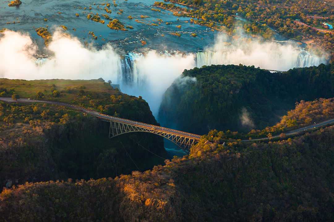 Aerial view of Victoria Falls: feel the misty spray and hear the roaring cascades of the 'Smoke That Thunders.