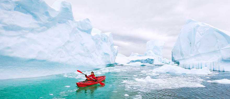 Kayaking around icebergs in Antarctica