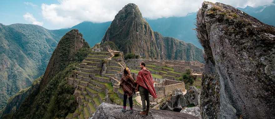 Couple at the great Inca city of Machu Picchu in Peru Couple at the great Inca city of Machu Picchu in Peru