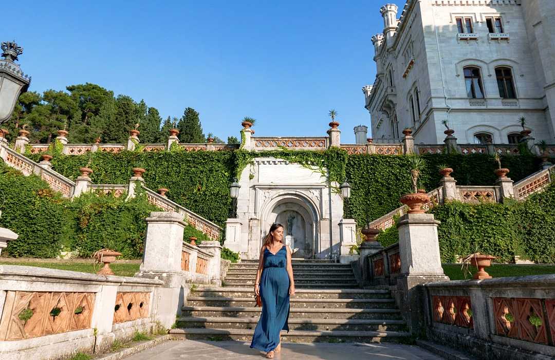 Woman walking the grounds at Castello di Miramare in Trieste, Italy