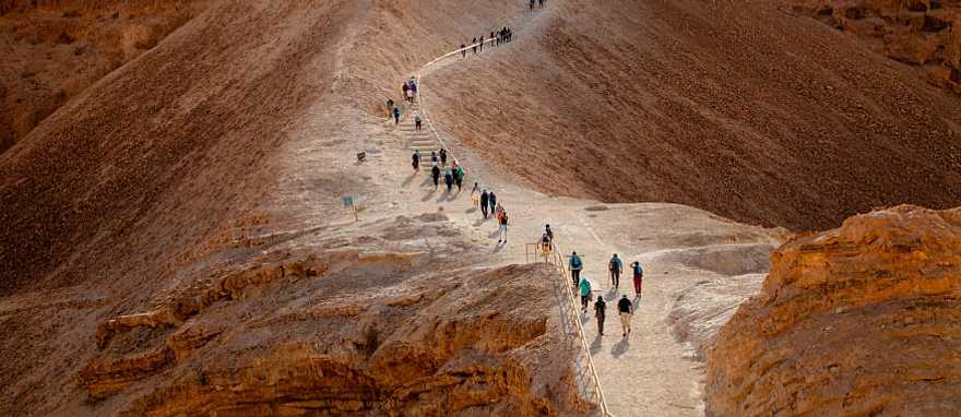 Tourist walking on Masada Fortress Rock in Israel
