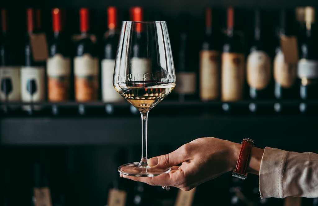 Woman holding wine glass showing the legs