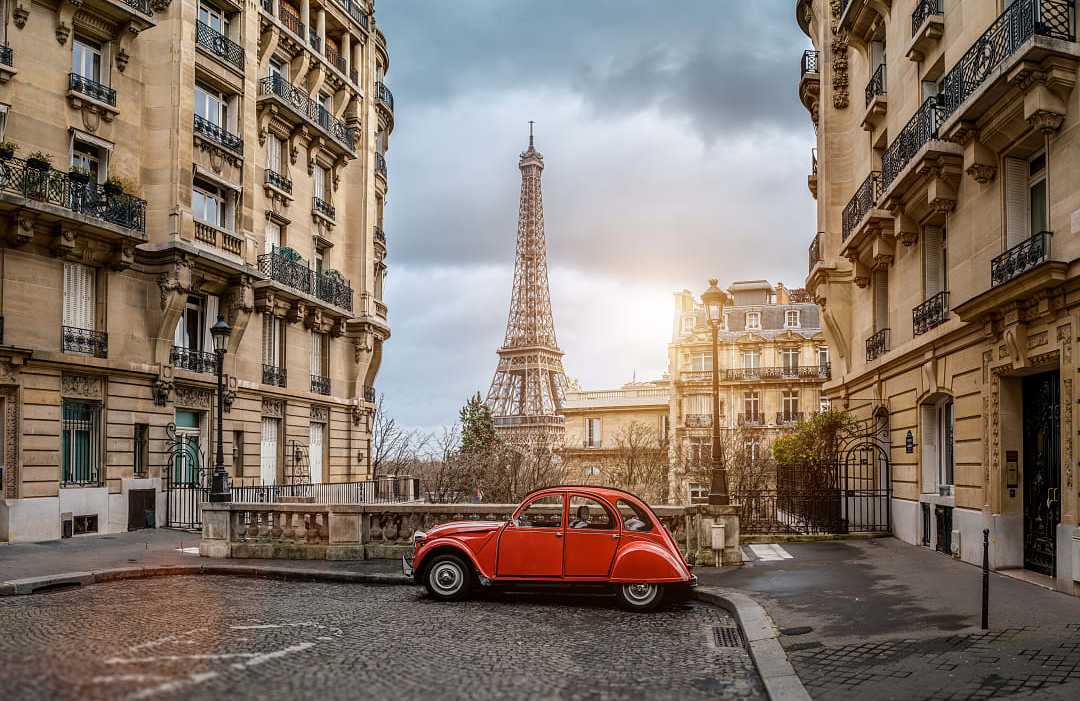 Small Paris street with view of the famous Eiffel Tower