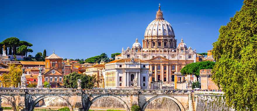 Vatican Dome of San Pietro Basilica and the Sant'Angelo bridge over Tiber river in Rome, Italy.