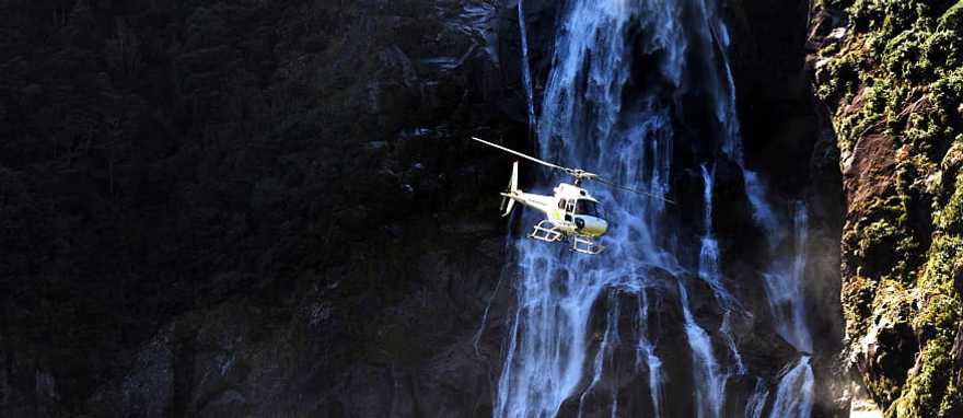 Fiordland National Park, New Zealand Helicopter flies over Fiordland National Park, New Zealand