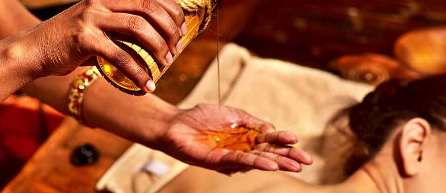 Ayurvedic Spa Treatment in India Women getting ayurvedic massage with oil in India.