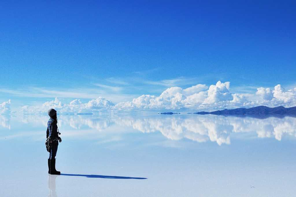 Woman with camera at Salar de Uyuni in Bolivia