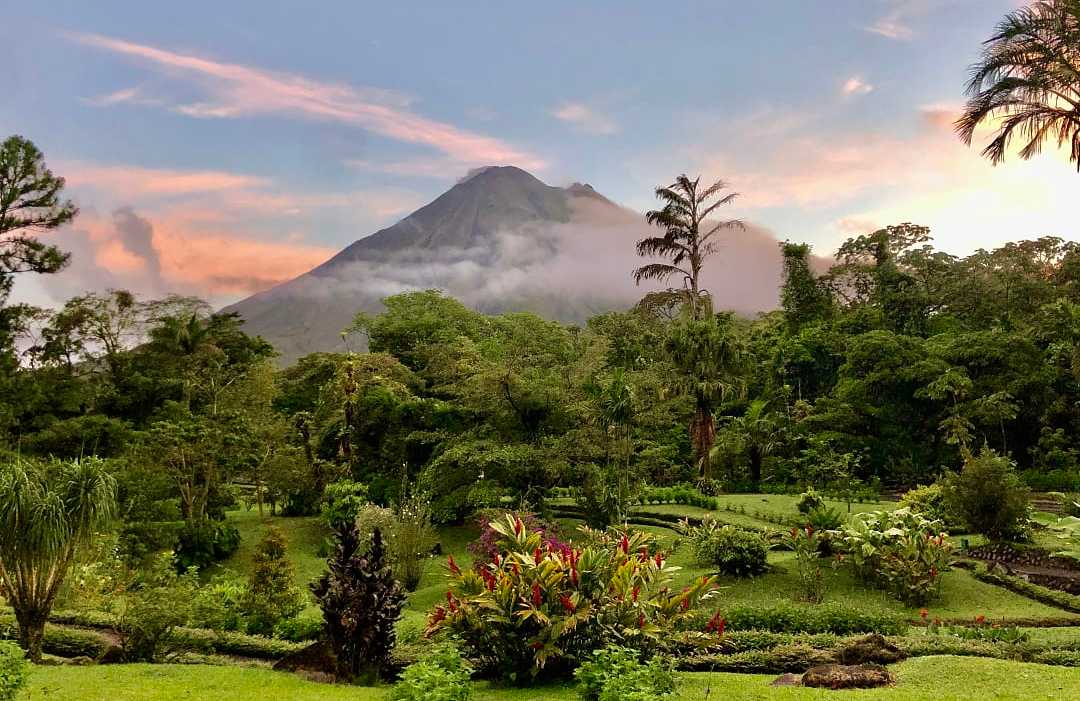 Arenal Volcano in Costa Rica, surrounded by lush rainforest.
