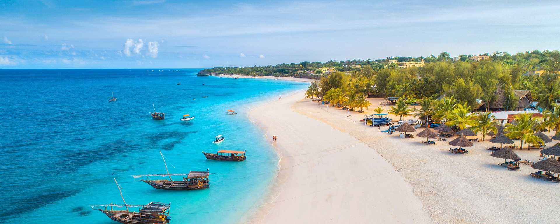 Bird's eye view of couple walking on the beach in Zanzibar, Tanzania