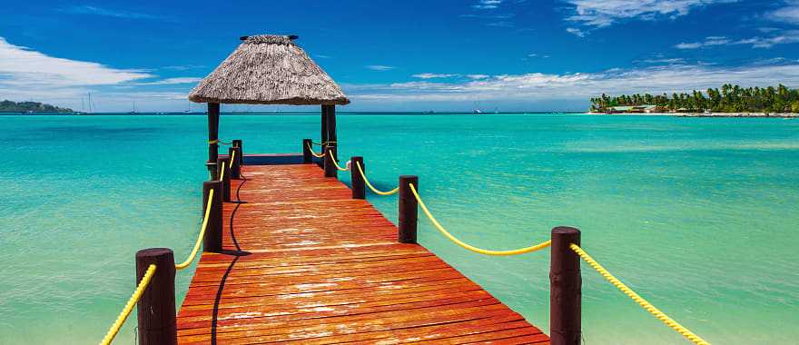 Wooden jetty on tropical beach in Fiji