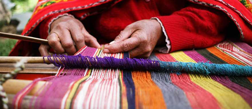 Woman weaving a traditional Peruvian blanket Woman weaving a traditional Peruvian blanket