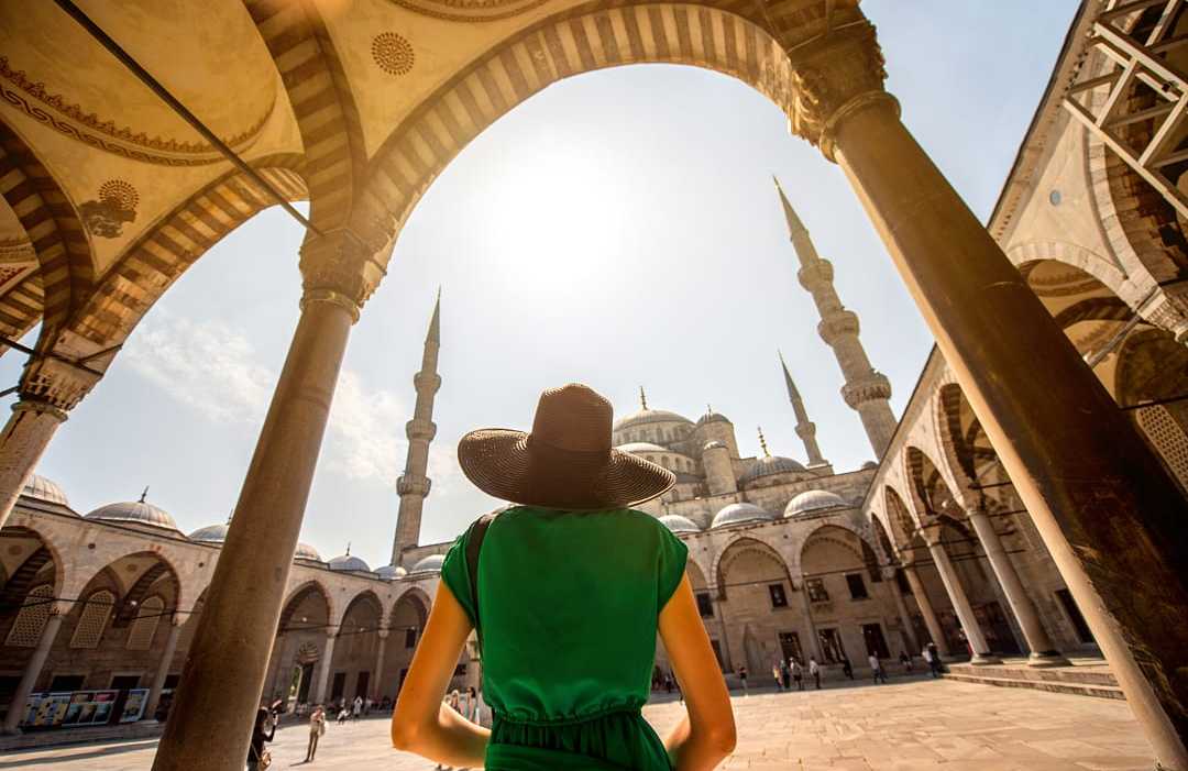 Woman visiting the Blue Mosque in Istanbul, Turkey