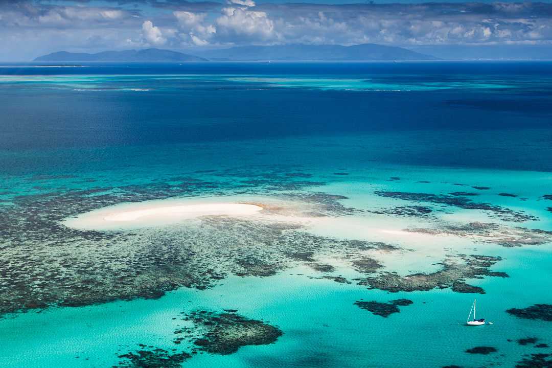 Breathtaking aerial view of the Great Barrier Reef, showcasing vibrant coral formations and turquoise waters in Queensland, Australia