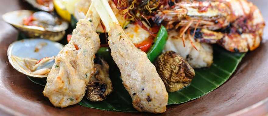 Indonesian-style seafood with grilled fish prawns and clams Indonesian-style seafood with grilled fish prawns and clams
