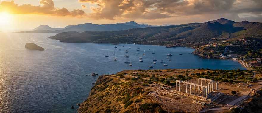 Aerial view of sunset over Cape Sounion with temple ruins in Greece Aerial view of sunset over Cape Sounion with temple ruins in Greece