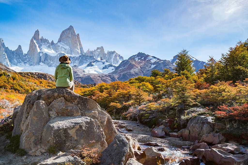 Adventure traveler in Patagonia enjoying Mt Fitz Roy and the autumn foliage.