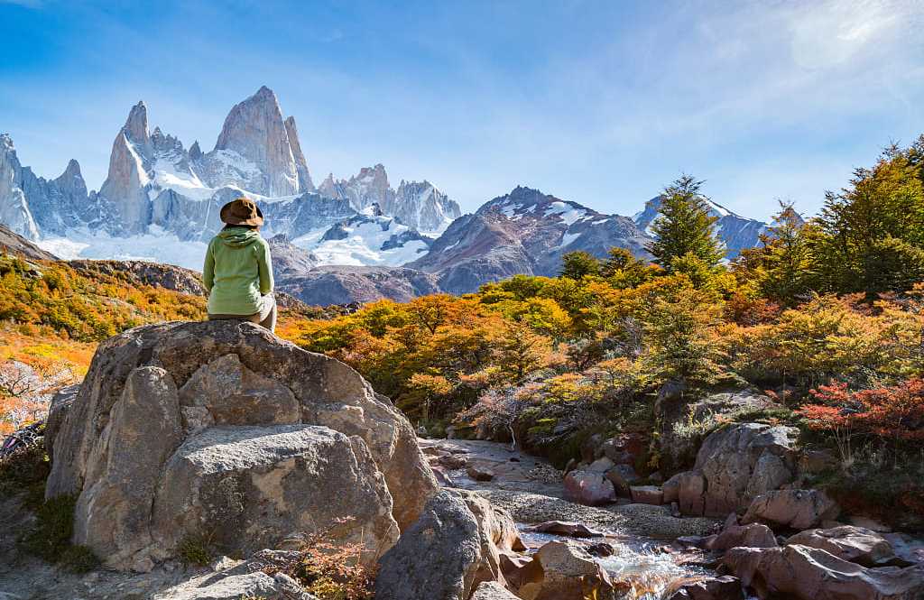 Adventure traveler in Patagonia enjoying Mt Fitz Roy and the autumn foliage.