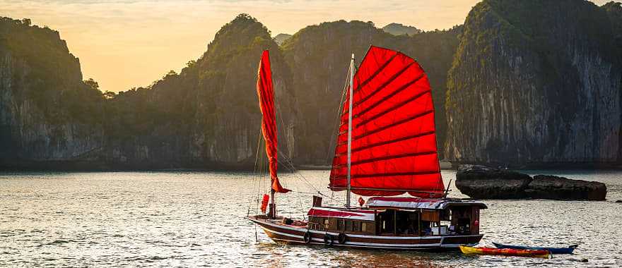 A red junk boat sailing in Ha Long Bay in Vietnam.