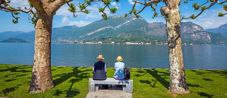 Senior couple enjoying the blue surface of Lake Como, Italy Senior couple enjoying the blue surface of Lake Como, Italy