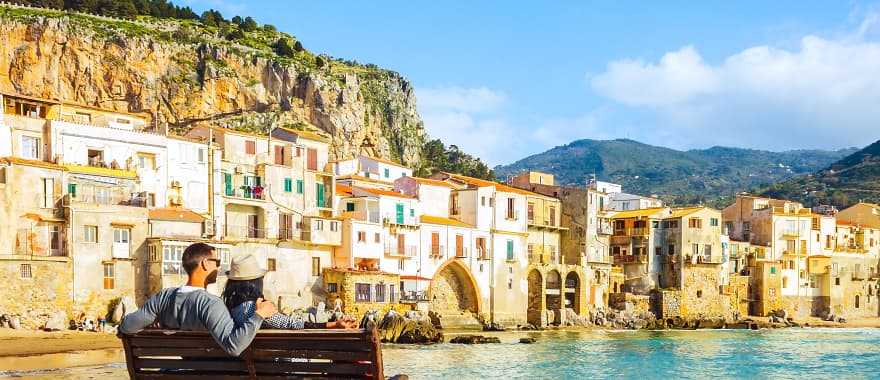 Traveling couple on the waterfront, Sicily