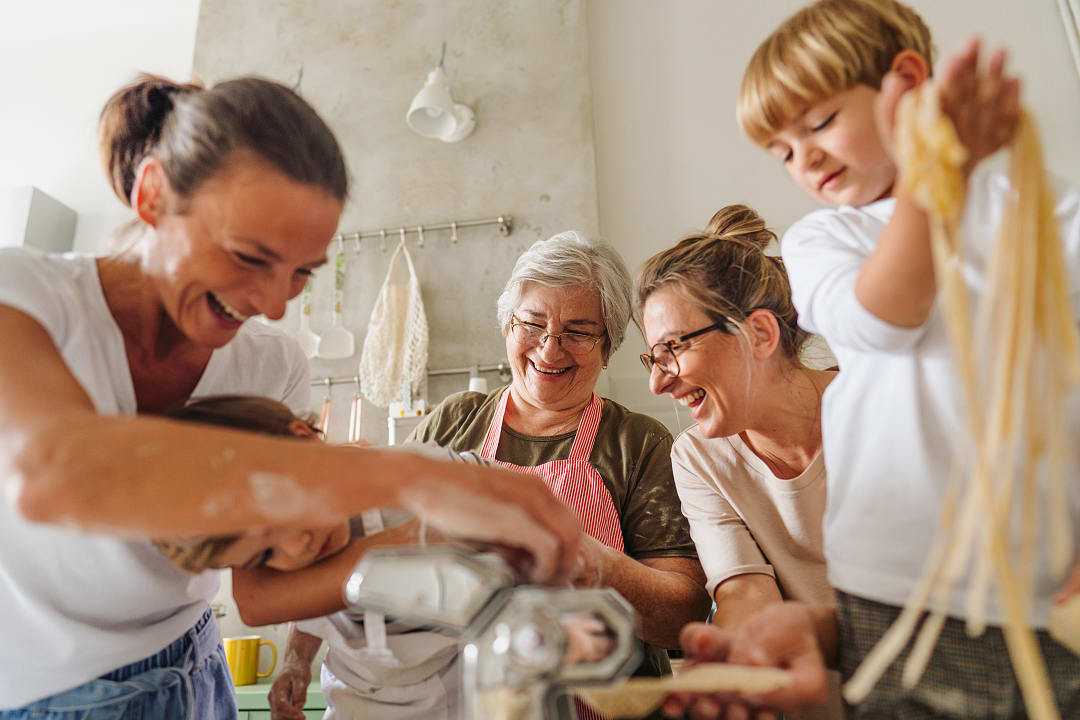 Family learning how to make pasta