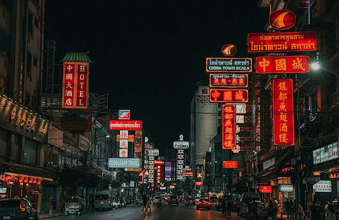 Neon-lit Chinatown street where Southeast Asia's street food culture thrives