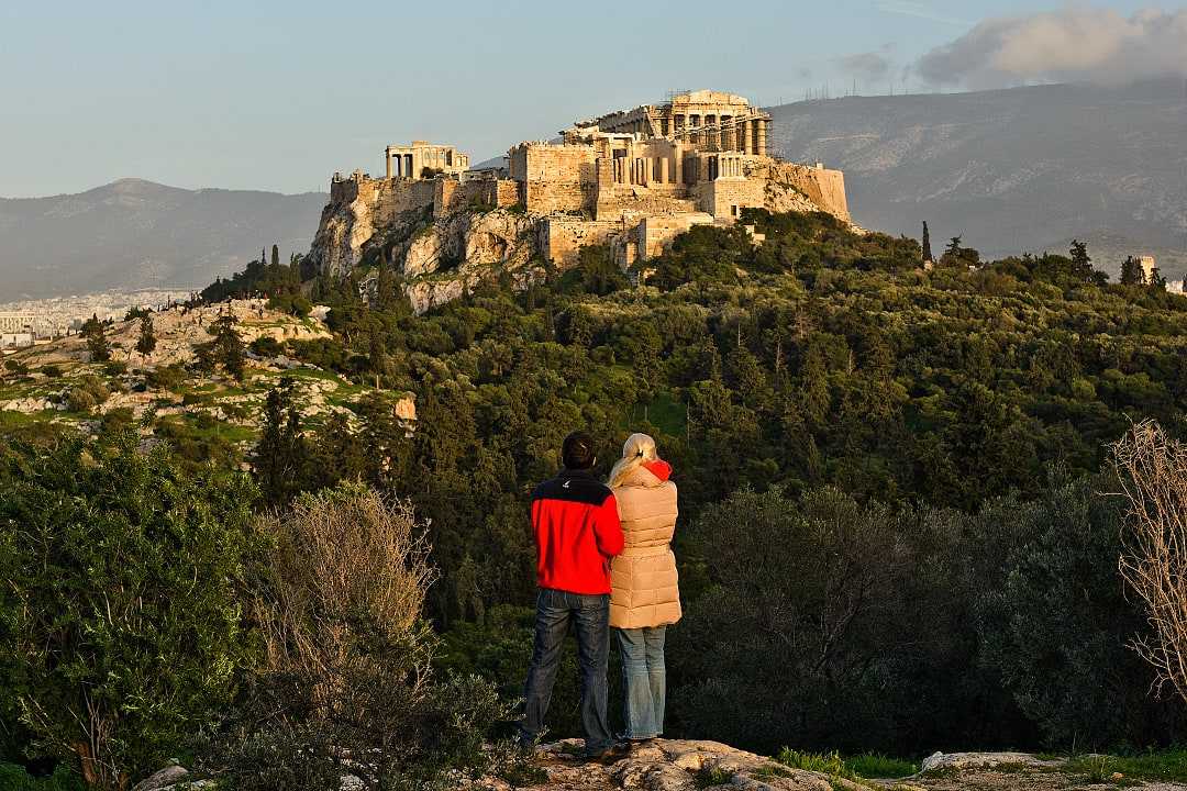 A couple admires the Acropolis in Athens