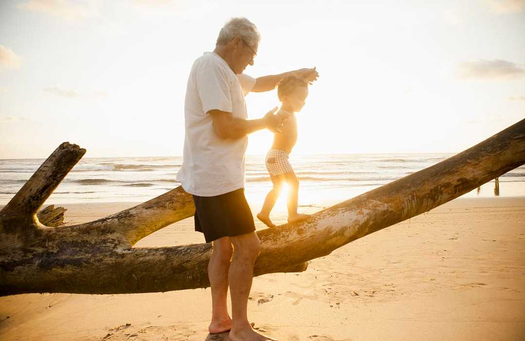Grandfather with his grandson on the beach in Latin America