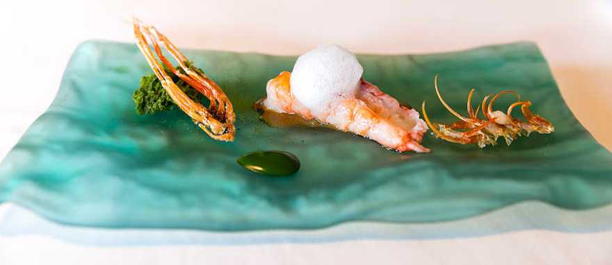 El Celler de Can Roca, in Girona Spain. Photo © City Foodsters / Flickr Whole prawn, charcoal-grilled king prawn, head juice with seaweeds, seawater and sponge cake of plankton served at El Celler de Can Roca, in Girona Spain