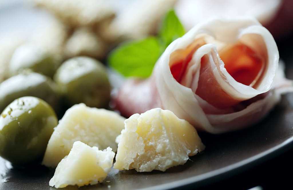 The famous Parma prosciutto and parmesan with green olives