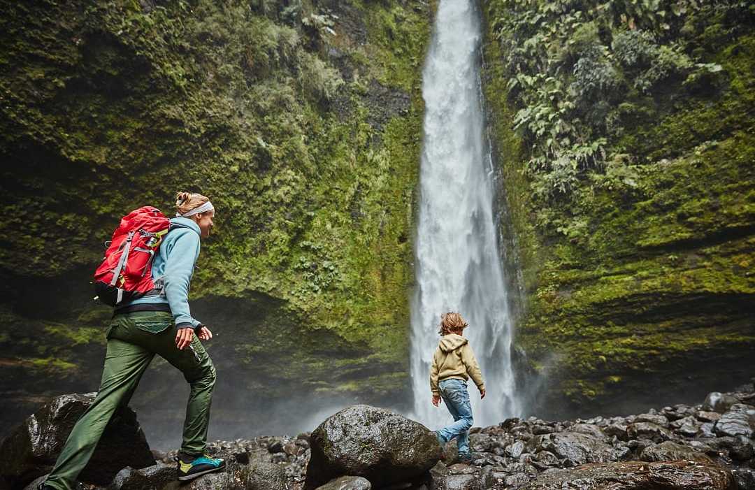 Mother and son on family vacation at Las Cascadas Waterfall in Chilean Patagonia