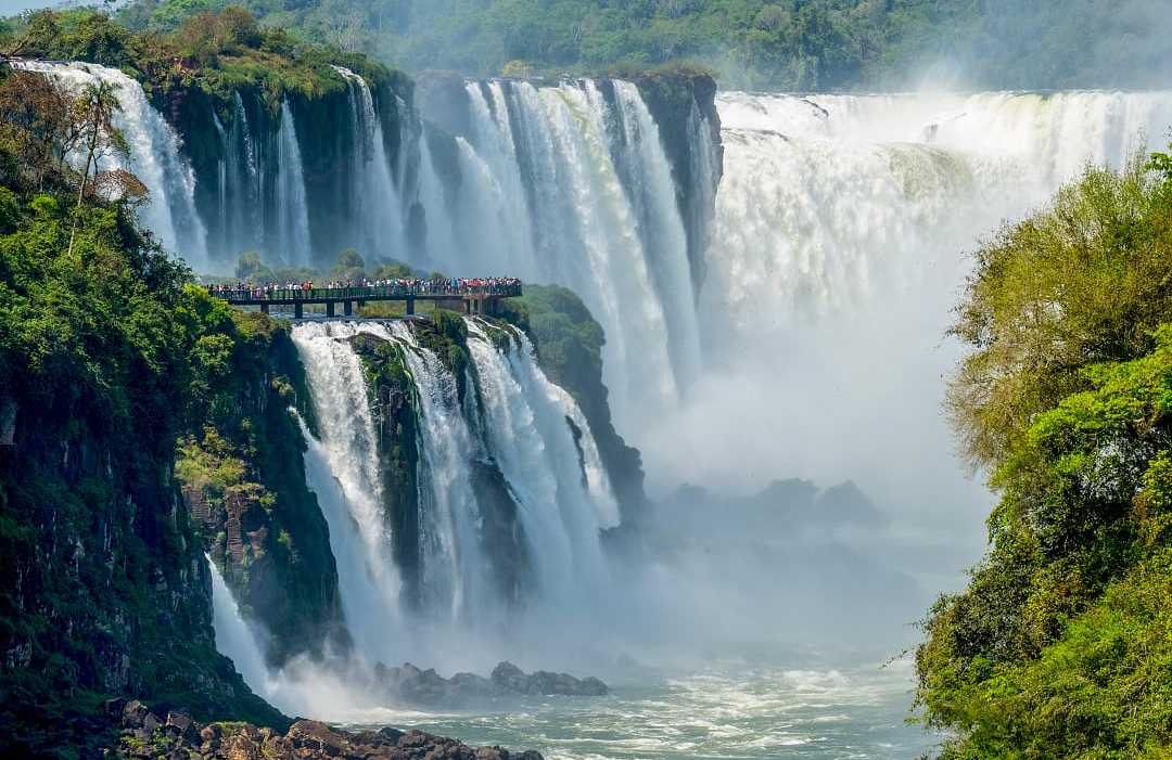 Travelers viewing The Devil's Throat from a platform on the Argentinian side of Iguazu Falls 